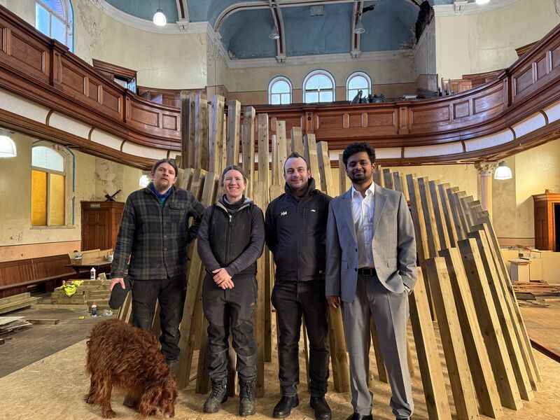 SHEANEY mentors and graduates beside the pavilion structure