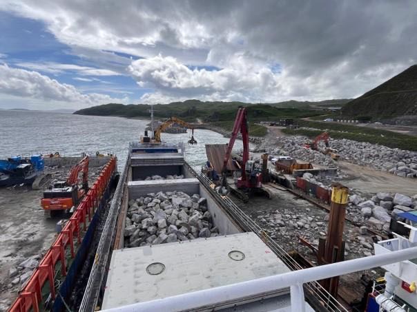 Rock armour delivery by barge for the terminal breakwater