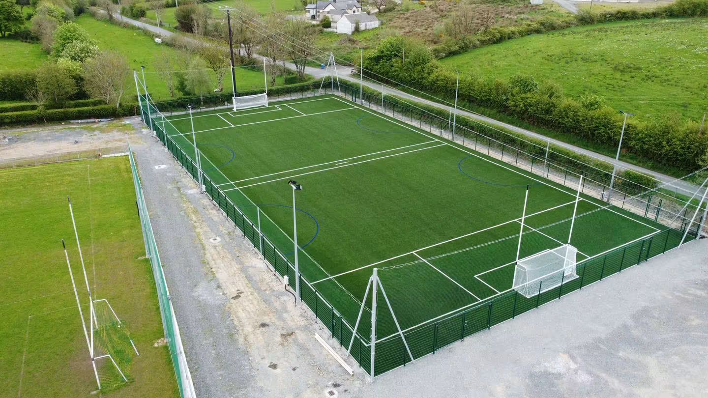 Angled aerial of the floodlit 4G pitch and perimeter fencing
